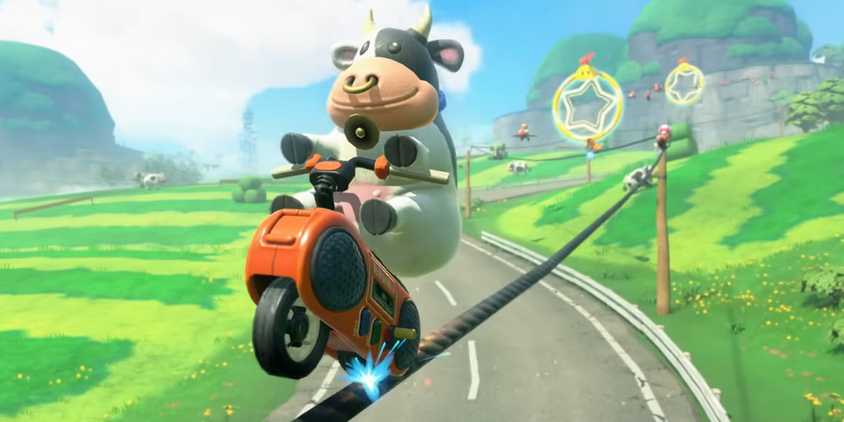 Mario Kart World Cow character racer doing a trick along an electrical wire.