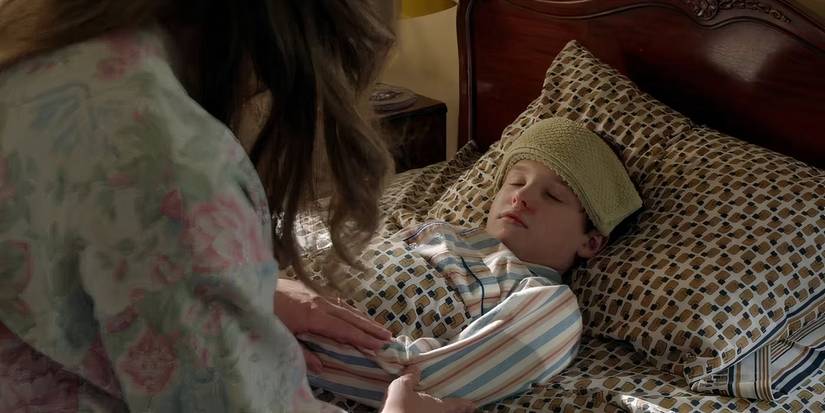 Mary Cooper sitting with a sick Sheldon in Young Sheldon