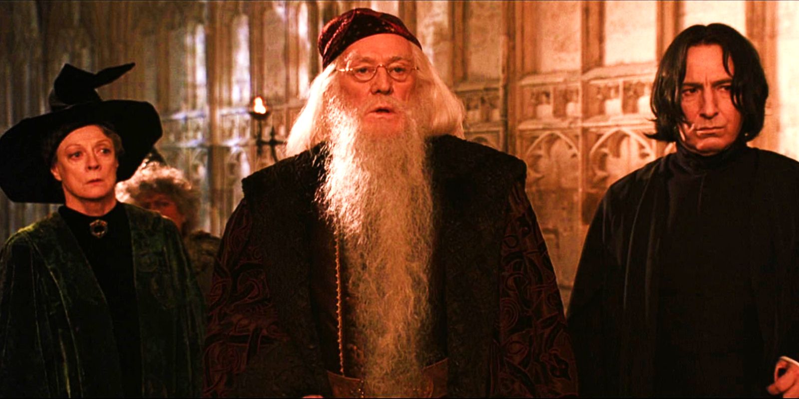 Richard Harris as Albus Dumbledore, Maggie Smith as Minerva McGonagall, and Alan Rickman as Severus Snape standing together in Harry Potter and the Chamber of Secrets.