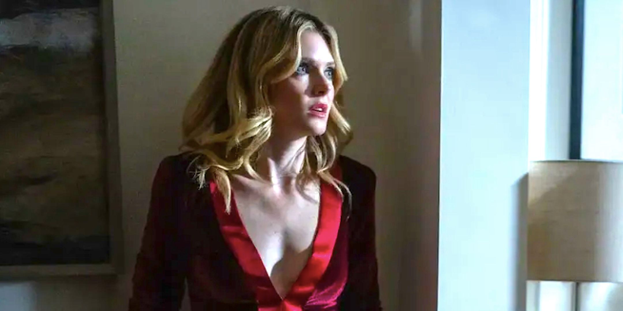 Meghann Fahy&rsquo;s Violet stands in a dark hallway in Drop 2025