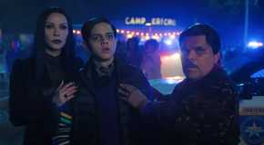 Morticia and Gomez Addams nervously holding onto Pugsley near a police car in Wednesday season 2