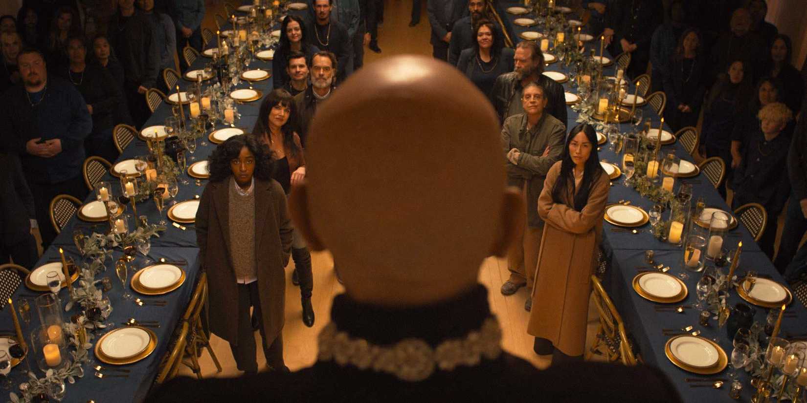 Alfred Moretti speaking in front of his guests at a dinner in Opus (2025)