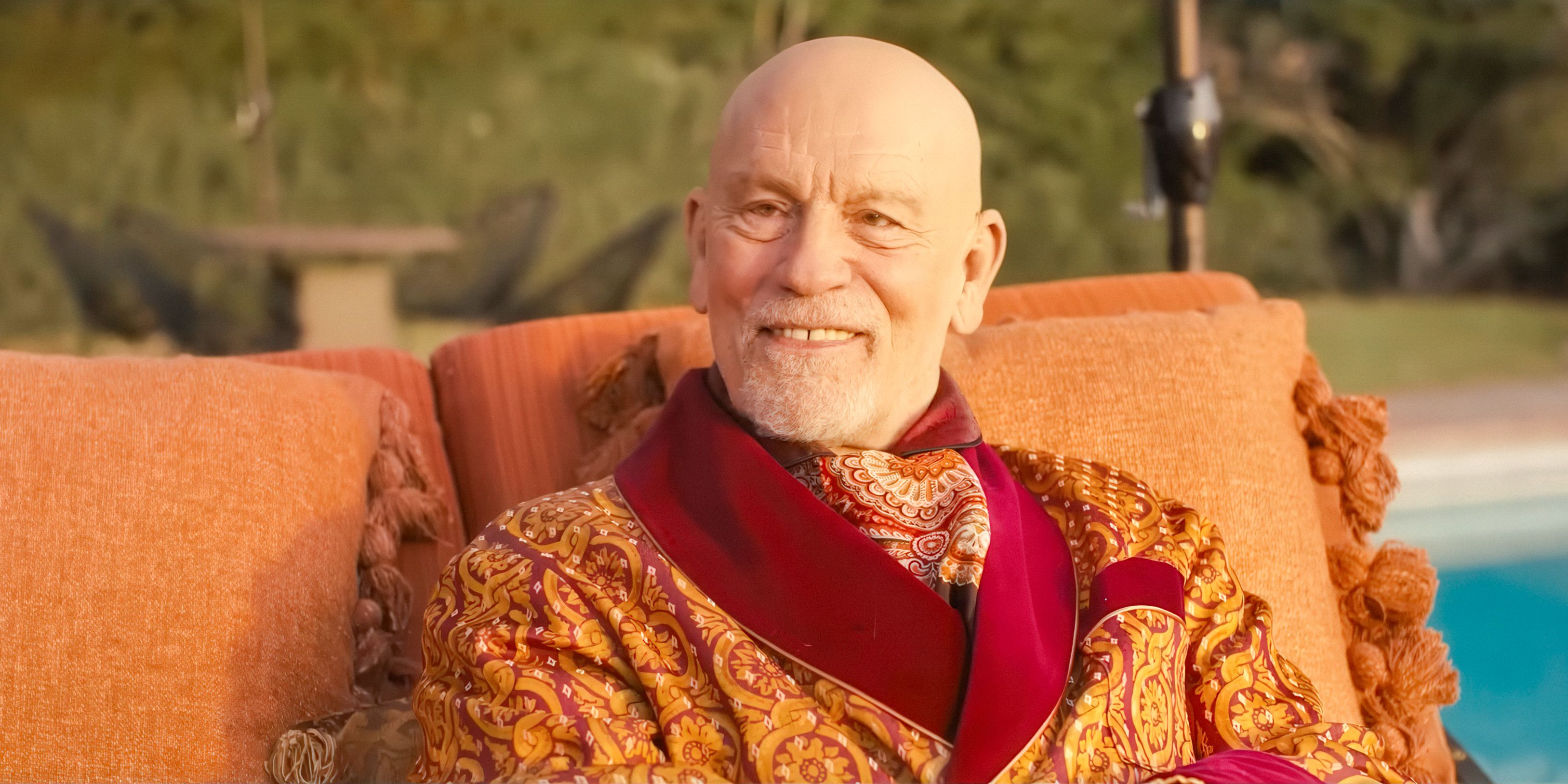 Alfred Moretti (John Malkovich) wearing a creepy smile in Opus (2025)