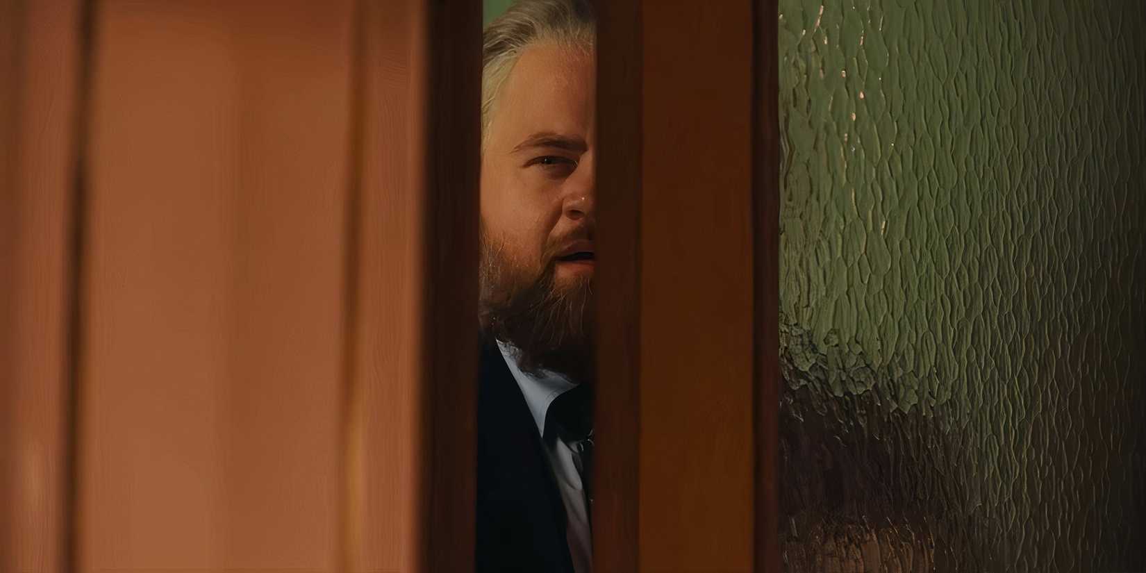 Paul Walter Hauser's Michael looking suspiciously through a doorway in The Luckiest Man in America