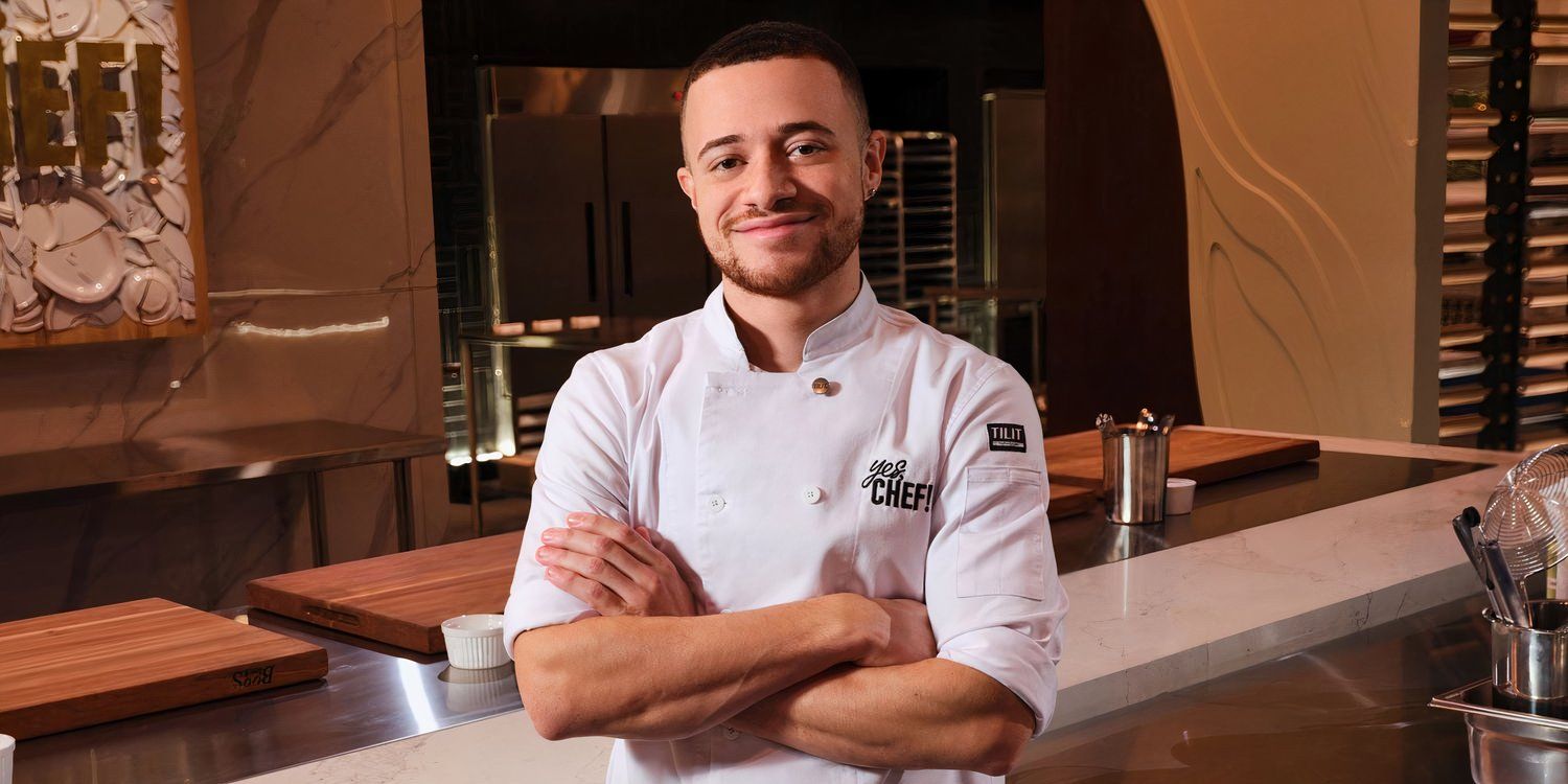 Peter posing, smiling with his arms crossed