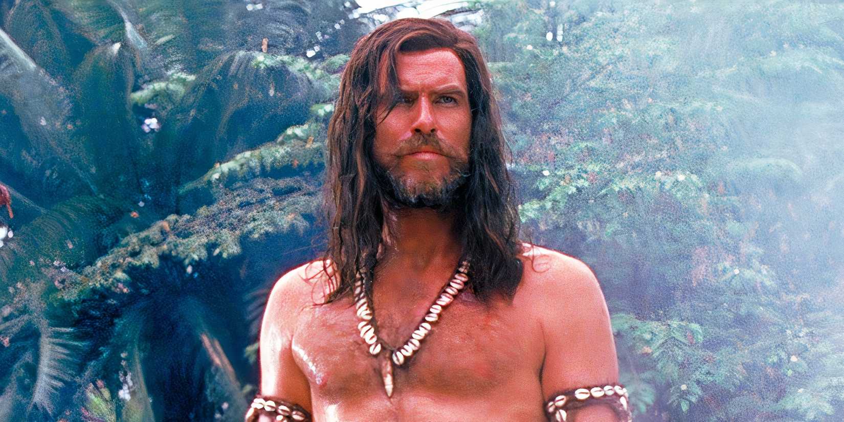 Pierce Brosnan standing shirtless in Robinson Crusoe