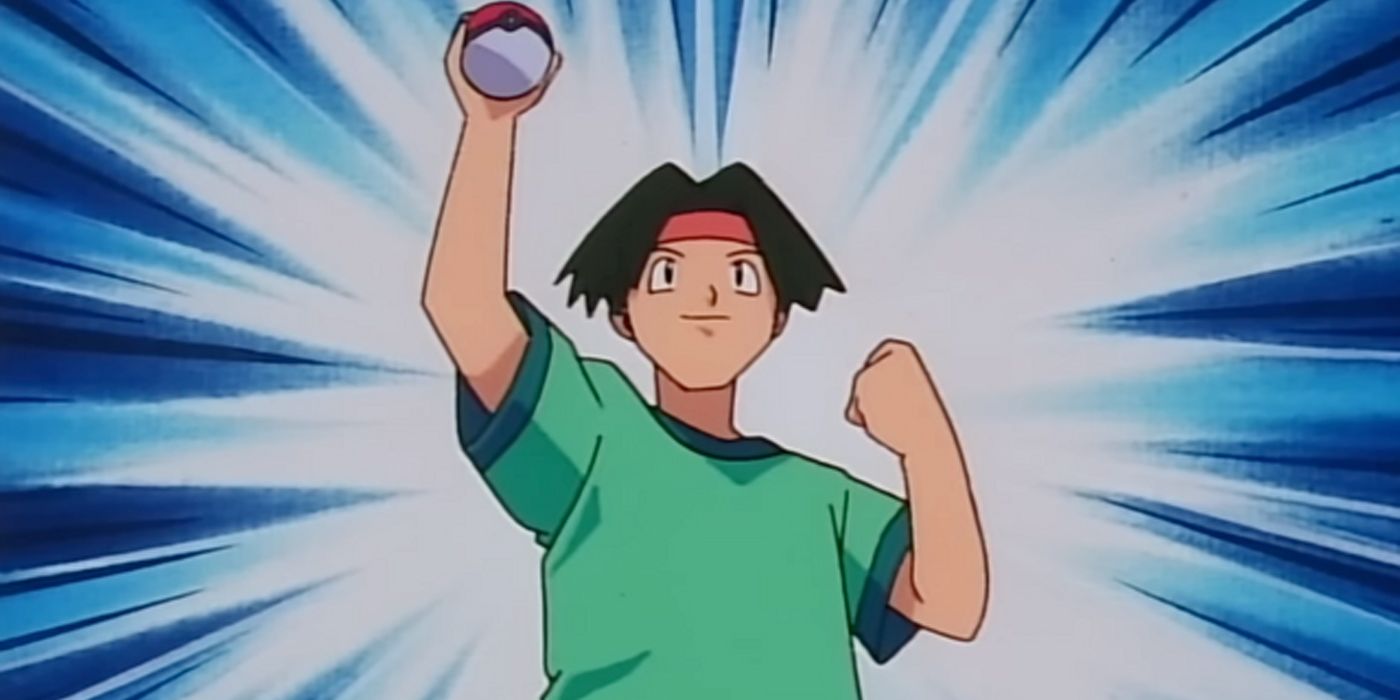 Tracey holds a poke ball over his head victoriously.
