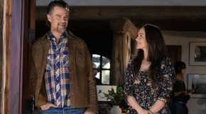 Quinn smiles up at Staten as they stand in a doorway in Ransom Canyon