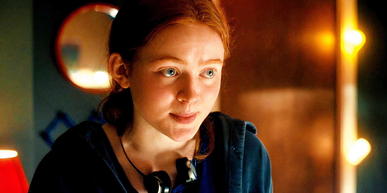Sadie Sink's Max smiles while wearing headphones in Stranger Things