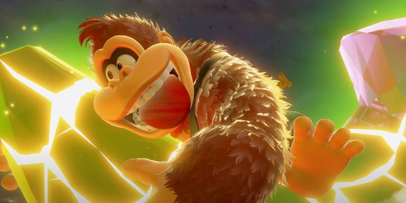 Donkey Kong grabs a glowing Banandium Gem in Donkey Kong Bananza