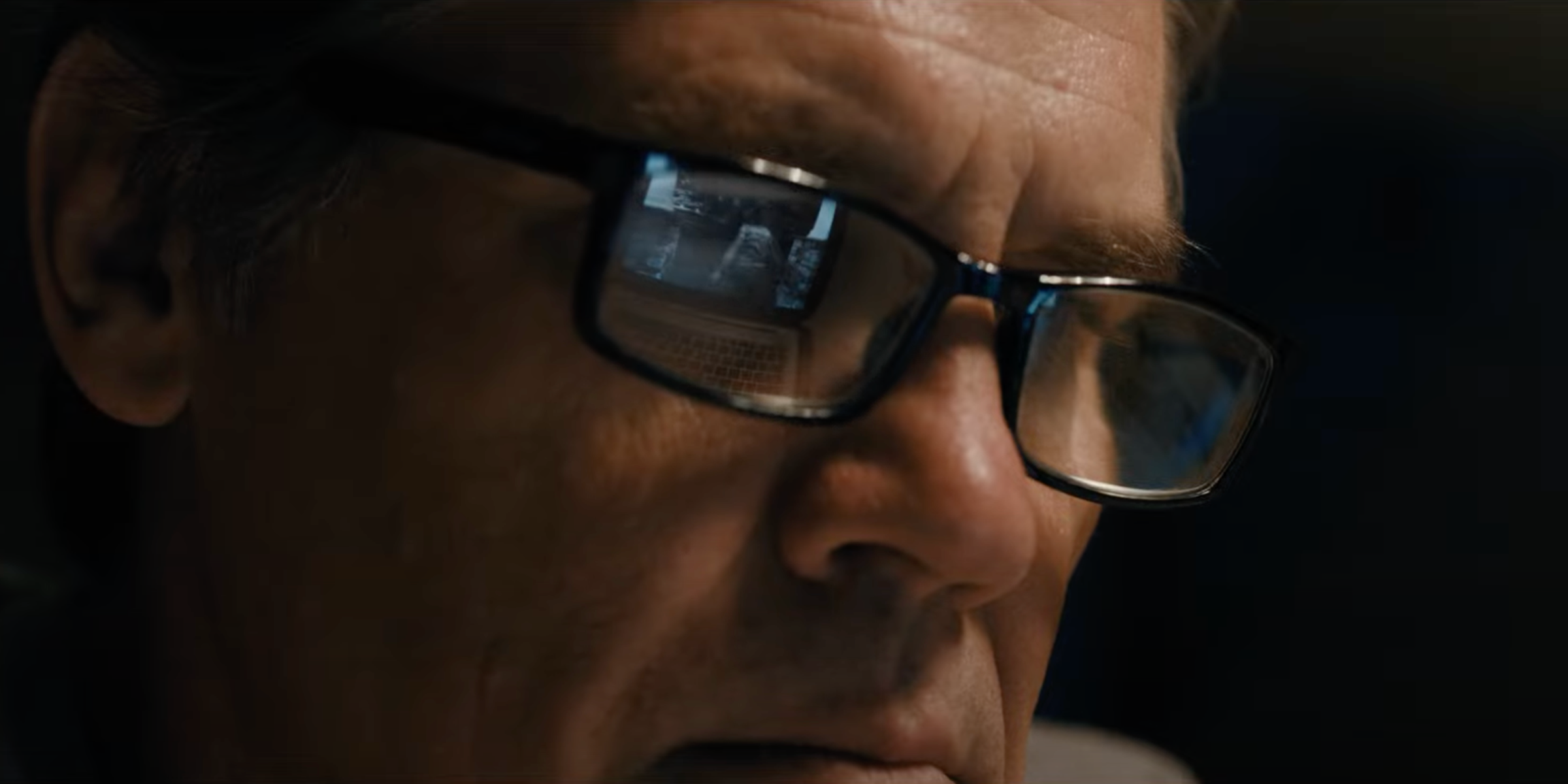 Josh Brolin with security footage reflected in glasses