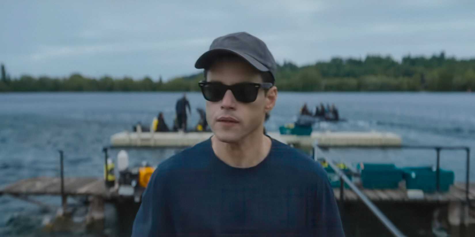 Heller (Rami Malek) wearing sunglasses and a cap in The Amateur