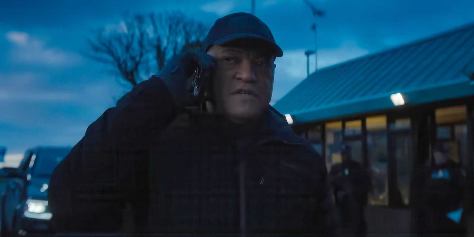 Henderson (Laurence Fishburne) talking on the phone in The Amateur