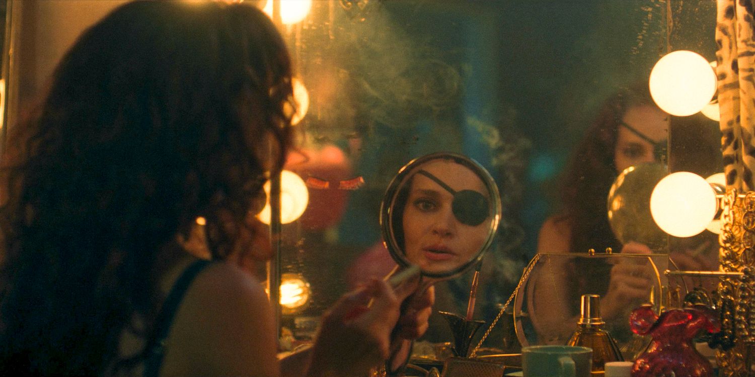 Janine (Madeline Brewer) looking at herself in a handheld mirror in The Handmaid's Tale Season 6 Ep 3