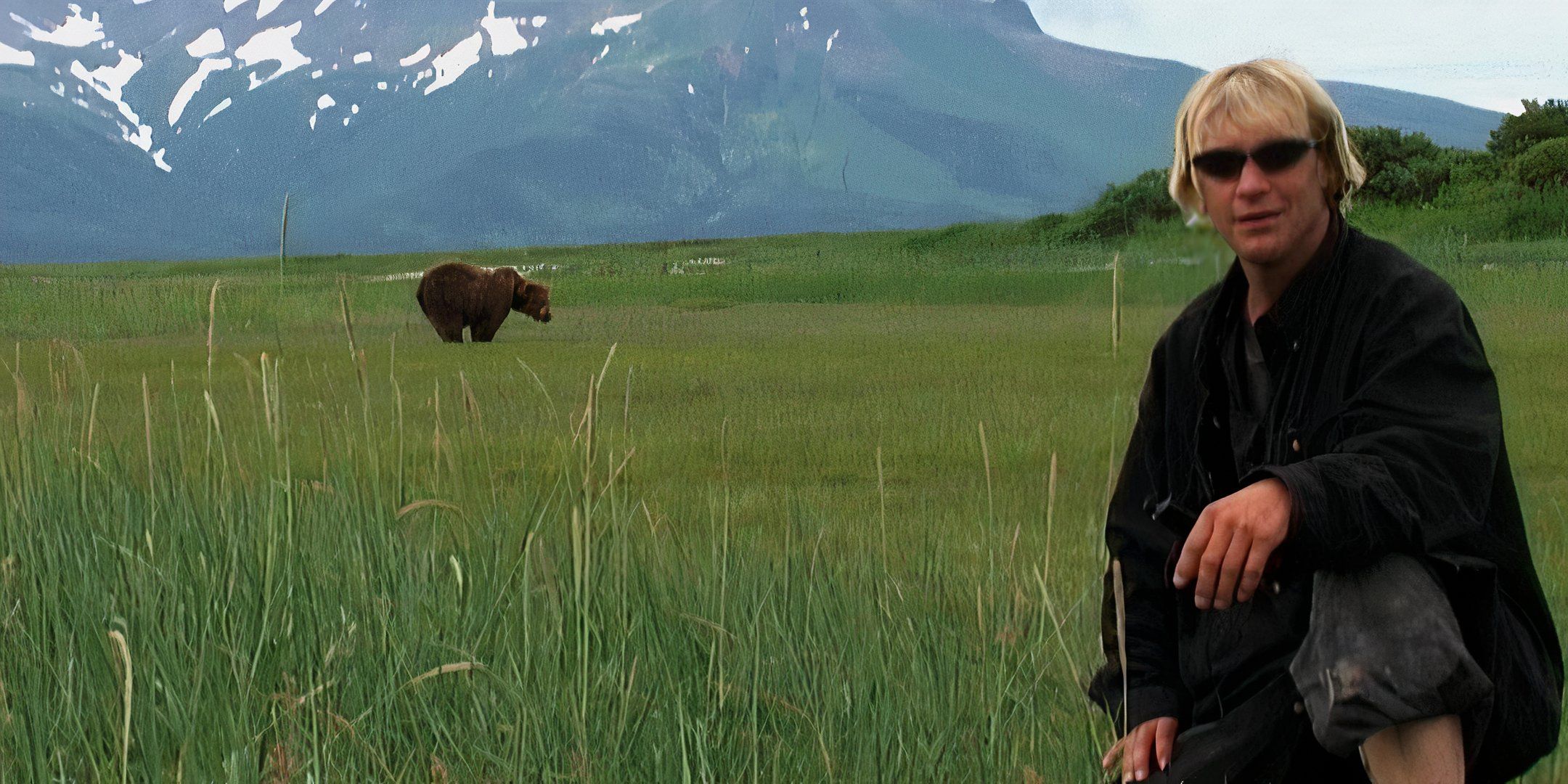 Timothy Treadwell poses with a bear from a distance. 