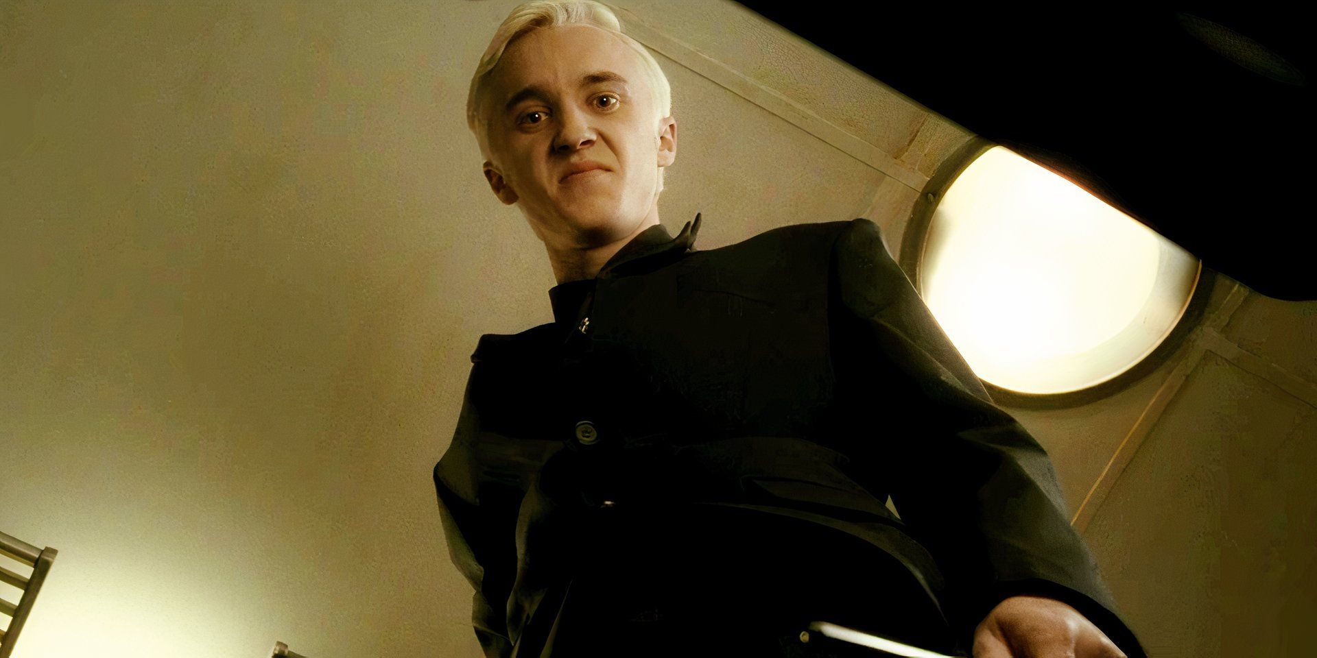 Tom Felton looking down at Harry Potter in Half Blood Prince