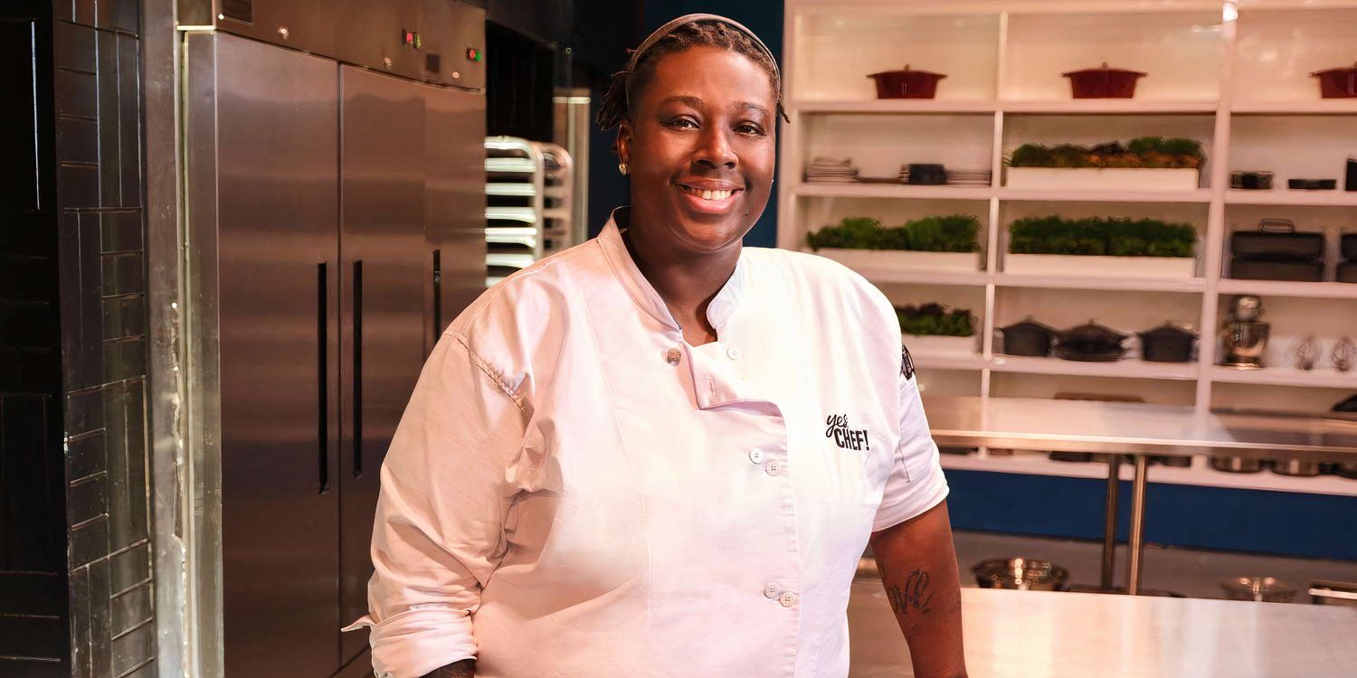 Yes, Chef! Torrece posing, smiling and leaning against a kitchen counter