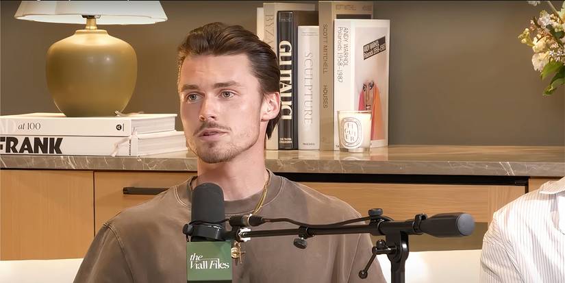 Tyler looking off screen with a mic sitting in front of him