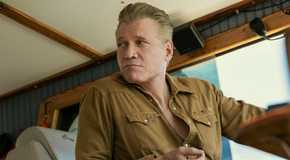 Holt McCallany driving a boat in The Waterfront