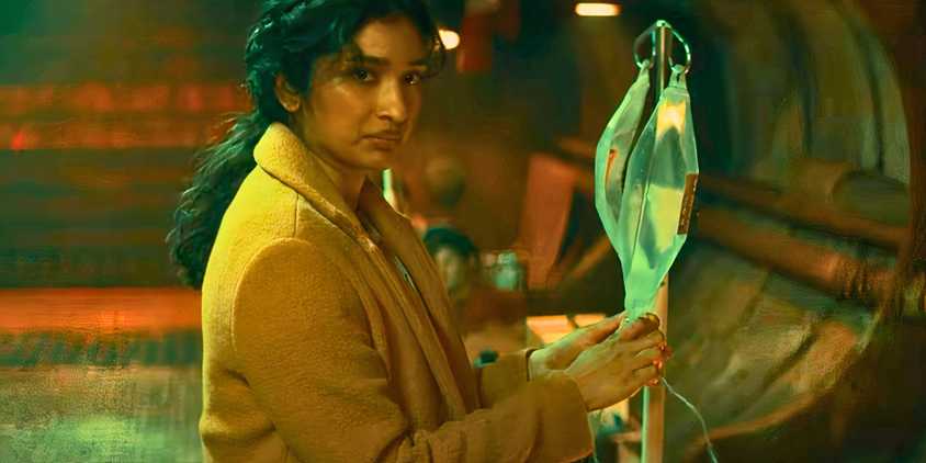 Varada Sethu as Belinda Chandra with an IV bag in Doctor Who