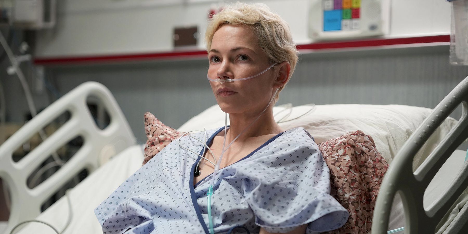 Molly sitting in a hospital bed with an oxygen tube in her nose