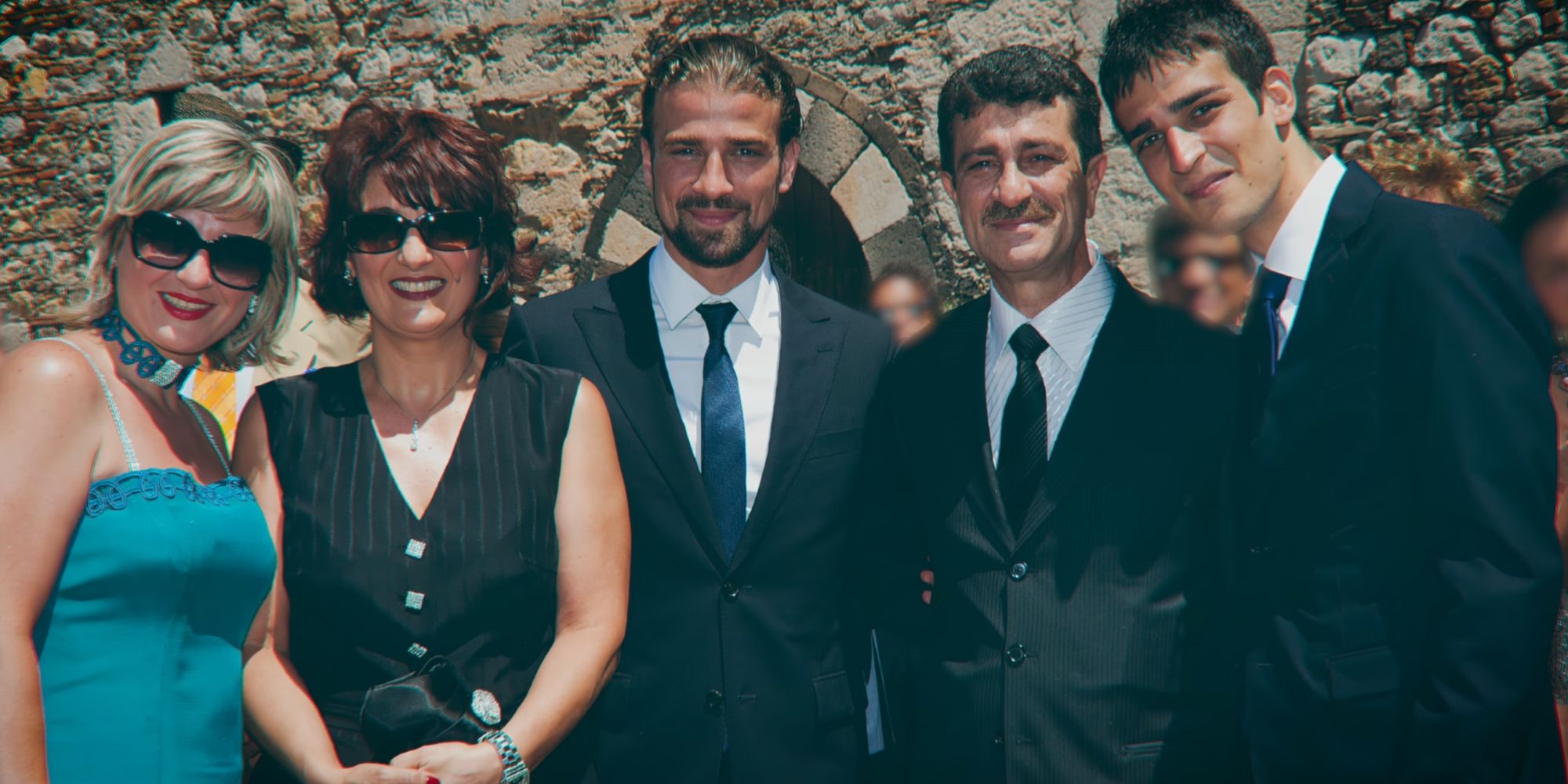 Mario Biondo poses in a suit and tie in the middle with the Biondo family