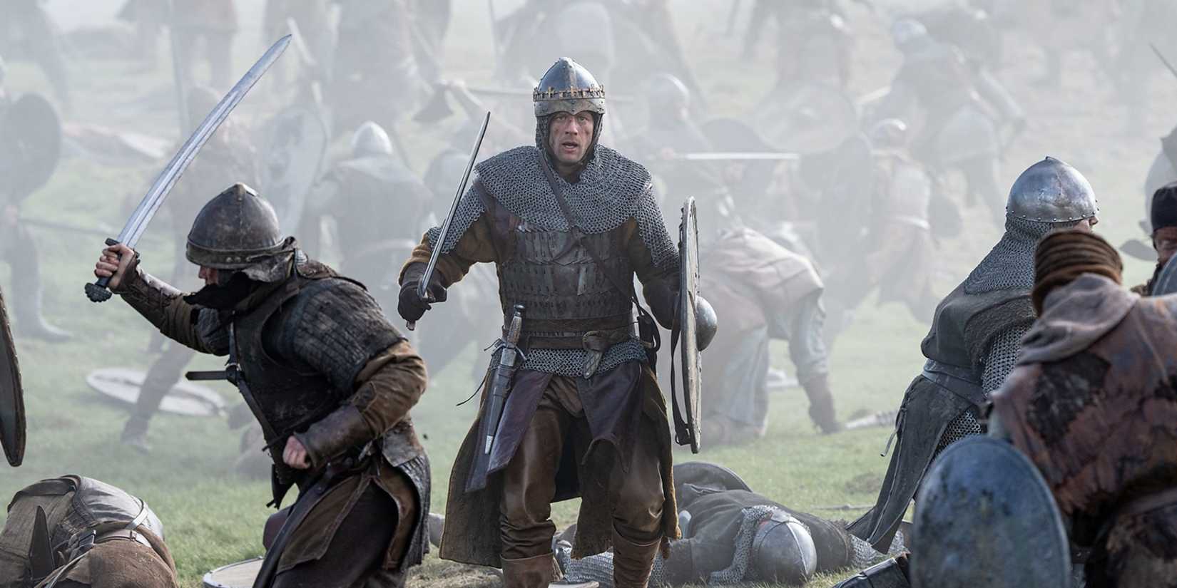 James Norton as Harold Duke of Wessex in the middle of a battlefield wearing armor and holding a sword and shield