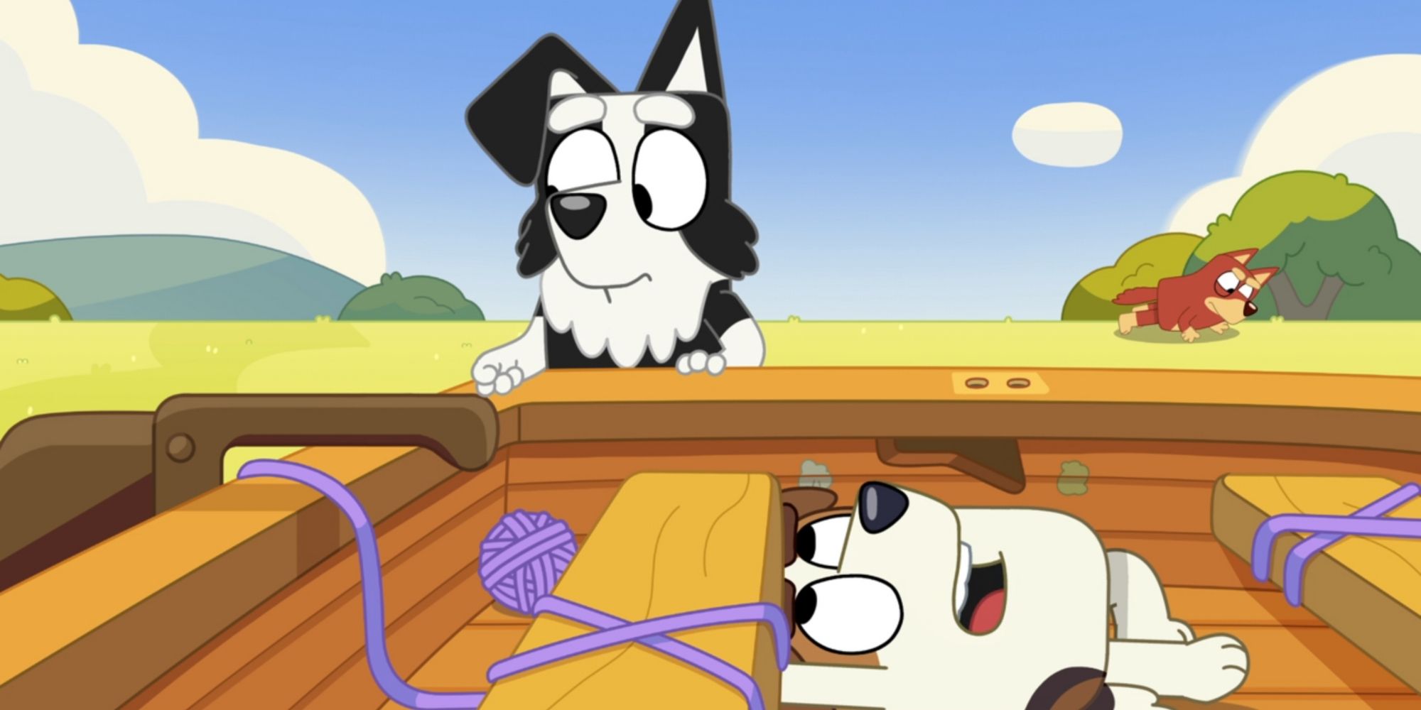 Mackenzie stands outside the boat as Jack lies down inside it