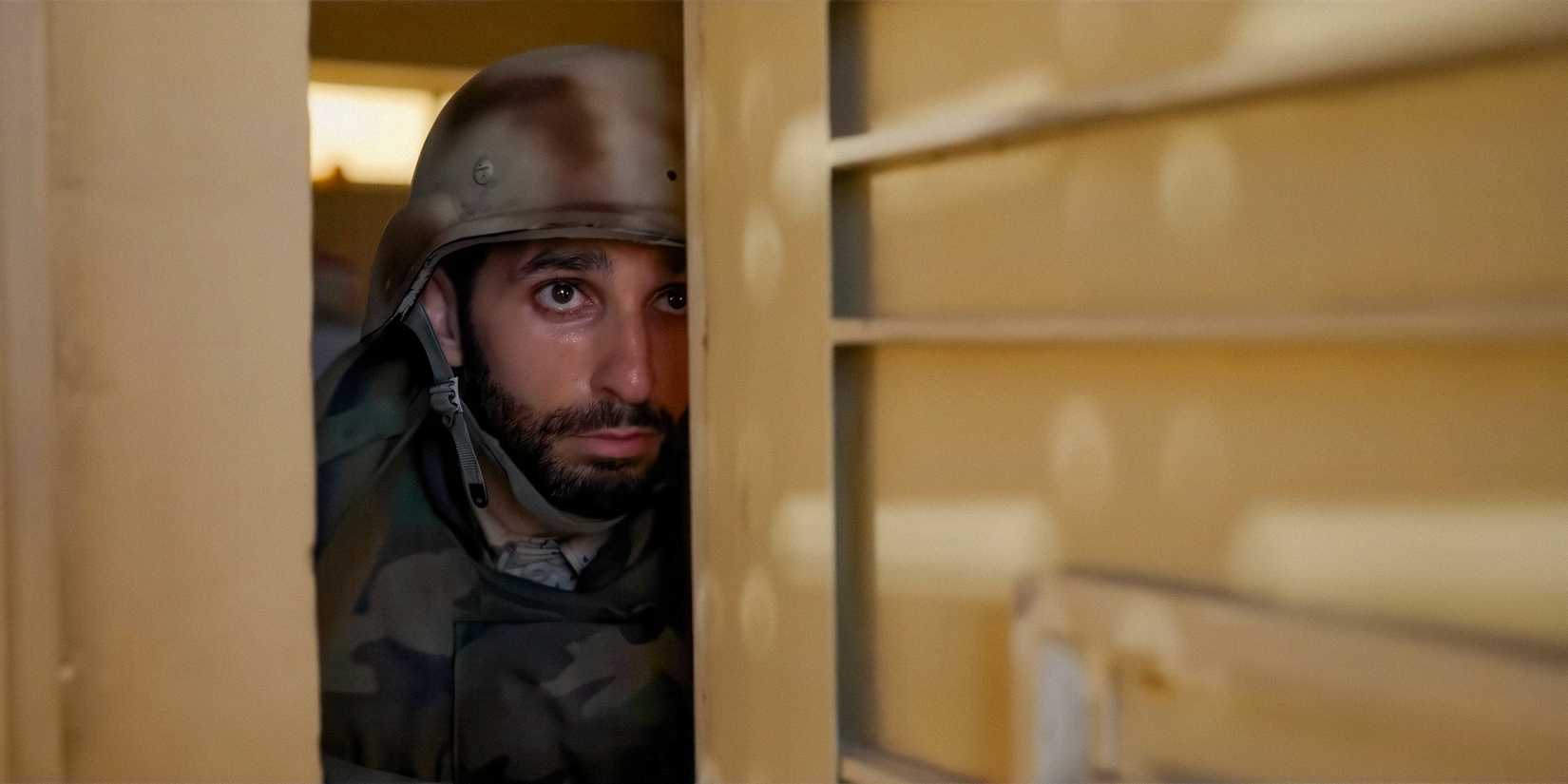 A soldier peeking out of a doorway in Warfare