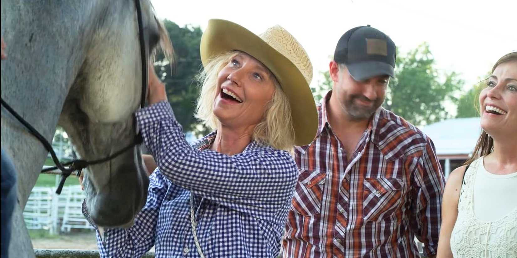 Anne Heche as Diana wearing a hat and petting a horse in Wildfire