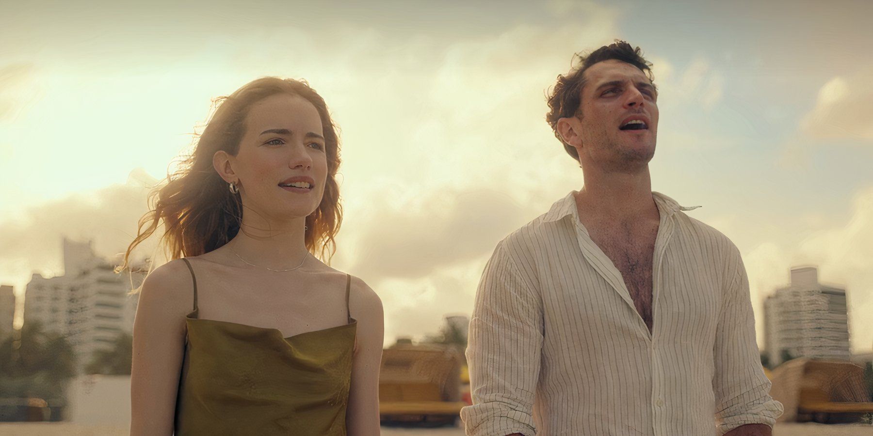 Willa Fitzgerald and Colin Woodell standing together outside in the daylight in Pulse