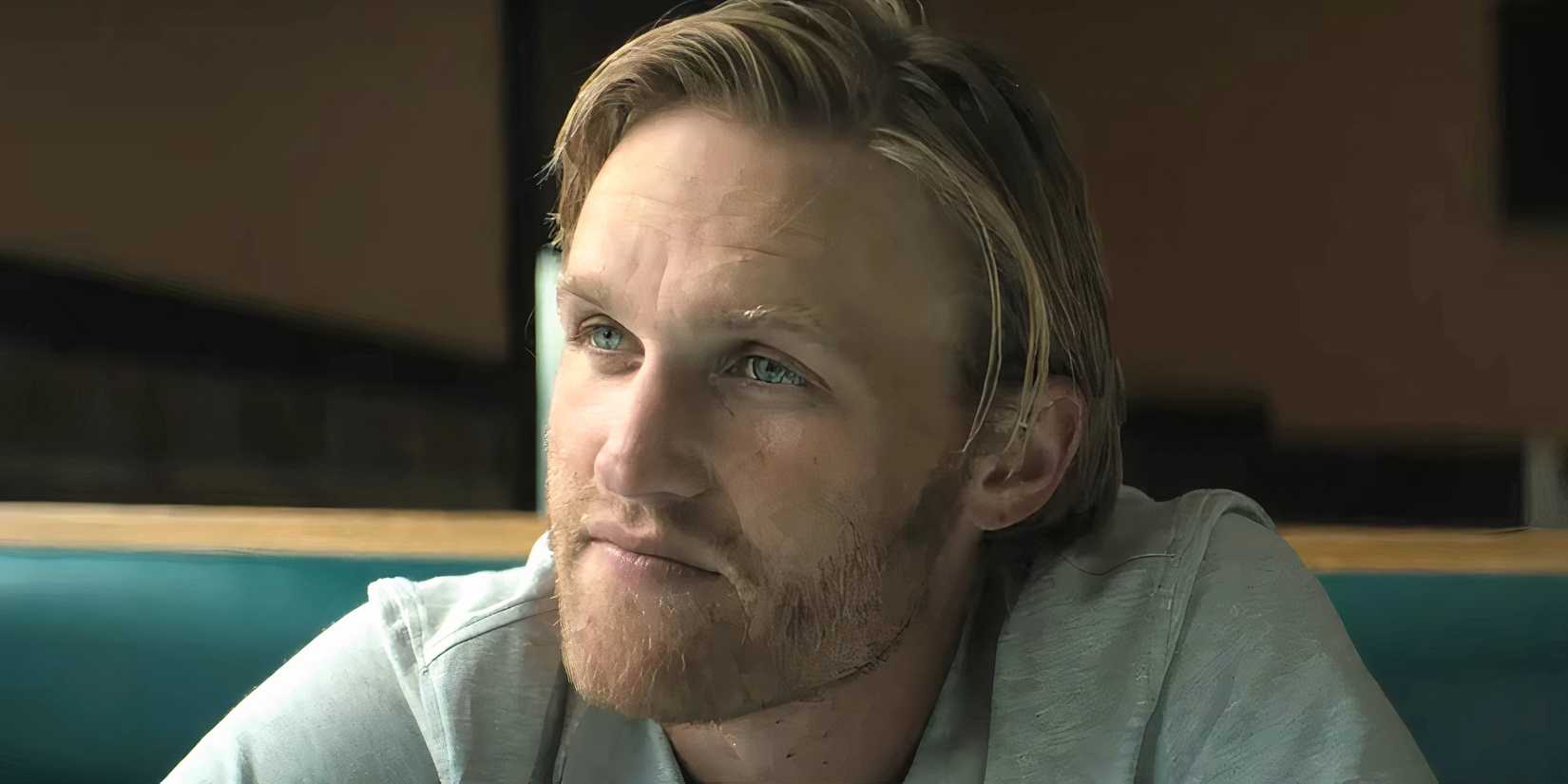Wyatt Russell as True looking thoughtfully at someone in Broke