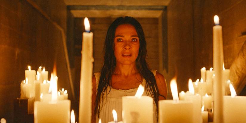 Adult Lottie (Simone Kessell) looking at an altar of candles in Yellowjackets Season 3 Ep 10