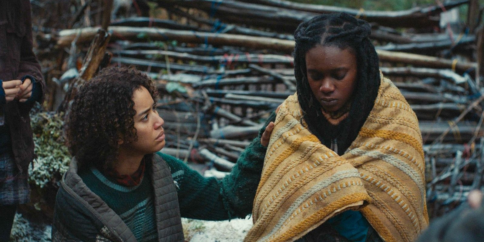 Teen Taissa (Jasmin Savoy Brown) comforting Akilah (Nia Sondaya) in Yellowjackets Season 3 Ep 10