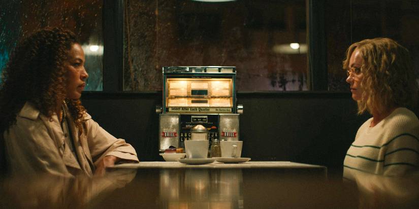 Taissa (Tawny Cypress) and Misty (Christina Ricci) sitting across from each other at a diner in Yellowjackets Season 3 Ep 10