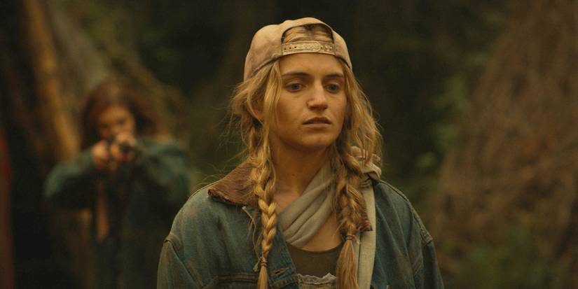 Teen Melissa stops as Shauna points a gun at her back in Yellowjackets season 3, episode 9