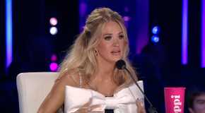 American Idol's Carrie Underwood speaking into the mic at the judging table