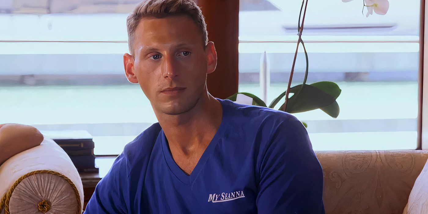 Below Deck's Fraser Olender staring off camera in a blue uniform shirt