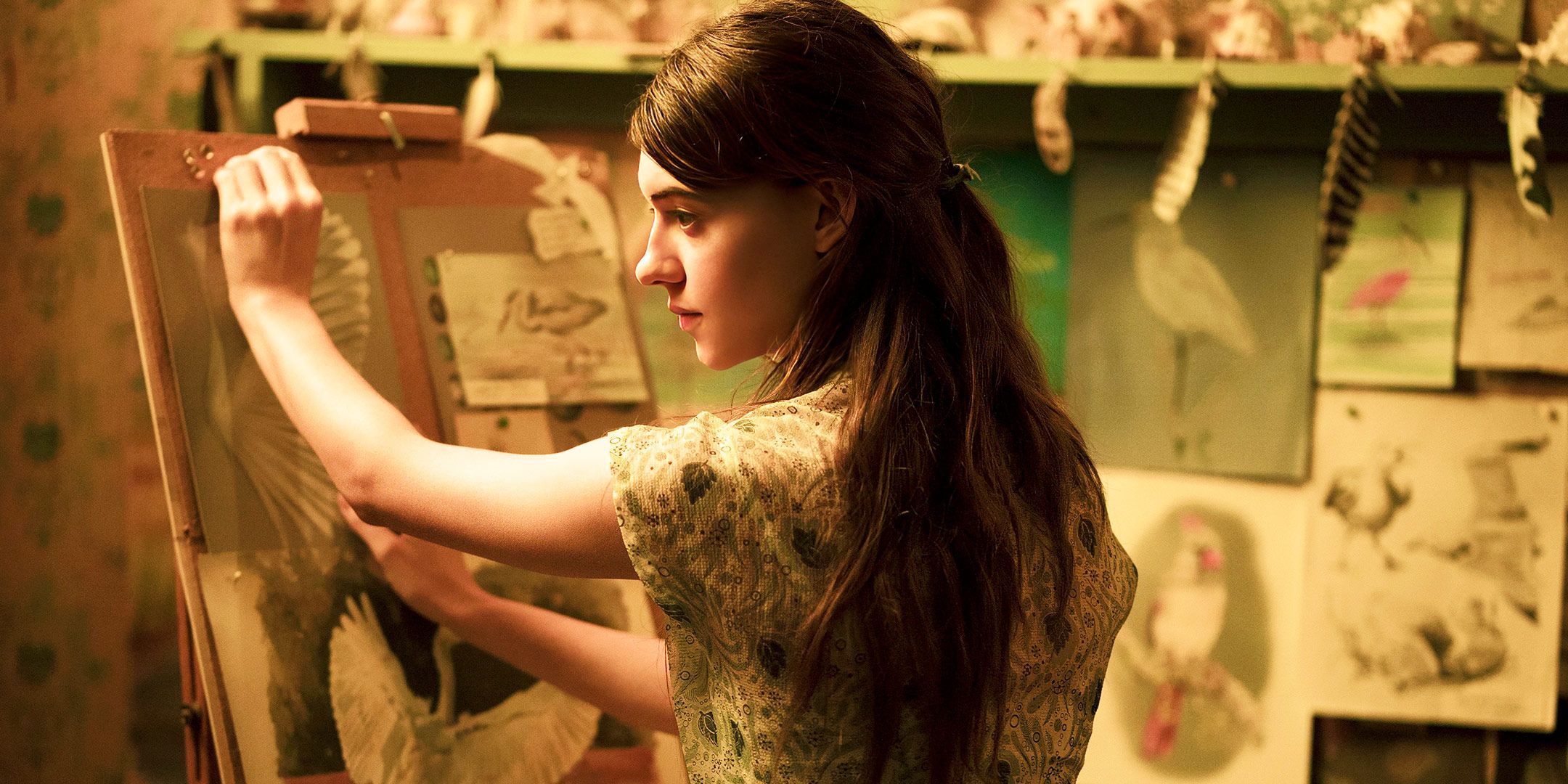 Daisy Edgar-Jones works on art in a scene from Where the Crawdads Sing