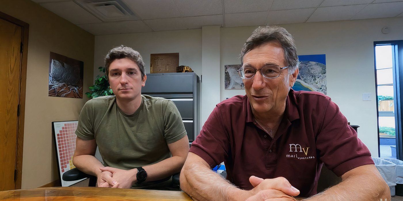 Alex Lagina and Marty Lagina on The Curse of Oak Island sitting side by side in a meeting