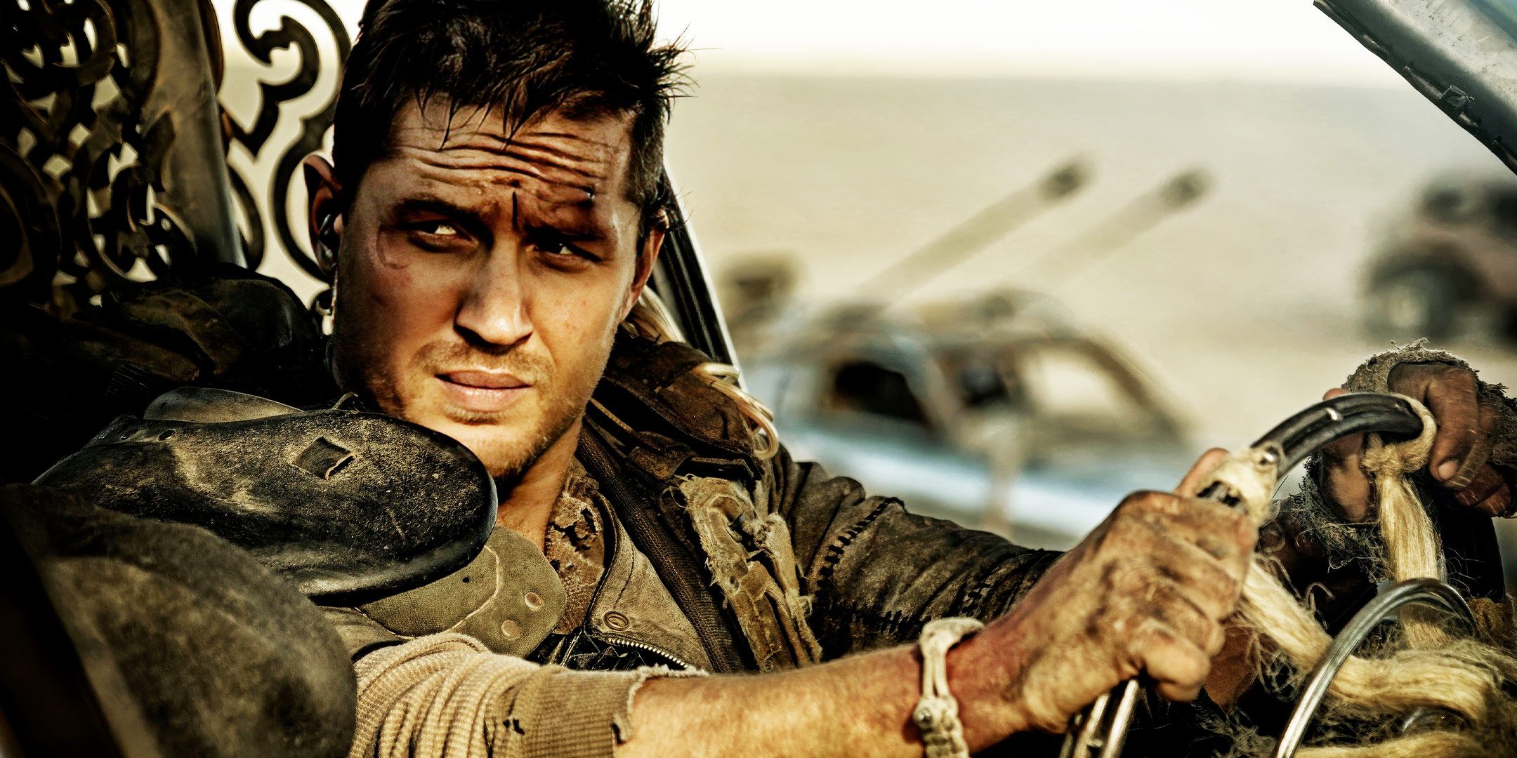 Tom Hardy grips a steering wheel in a scene from Mad Max: Fury Road