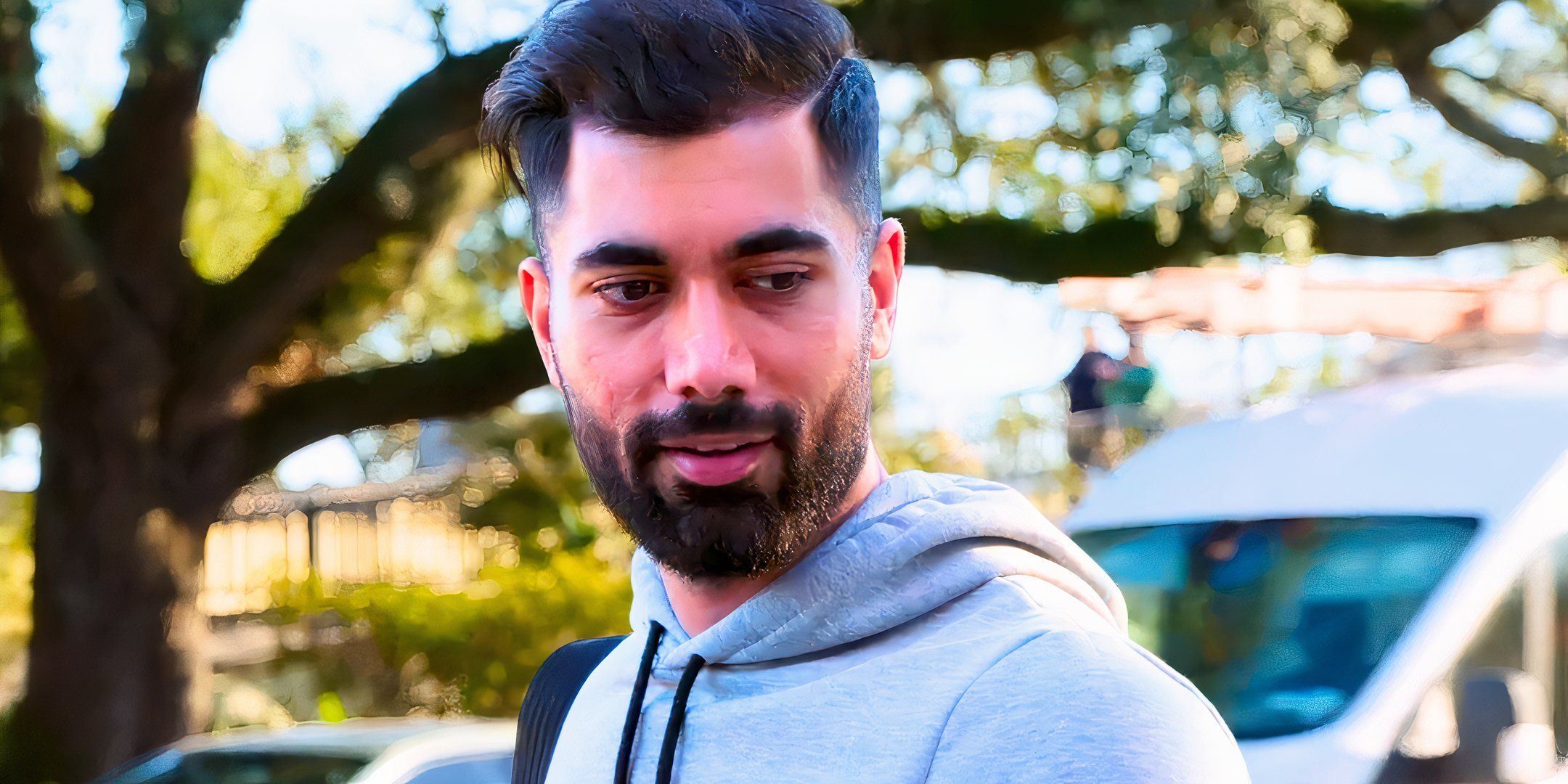 A close up of 90 Day Fiancé’s Mahdi Al-Saadi standing outdoors