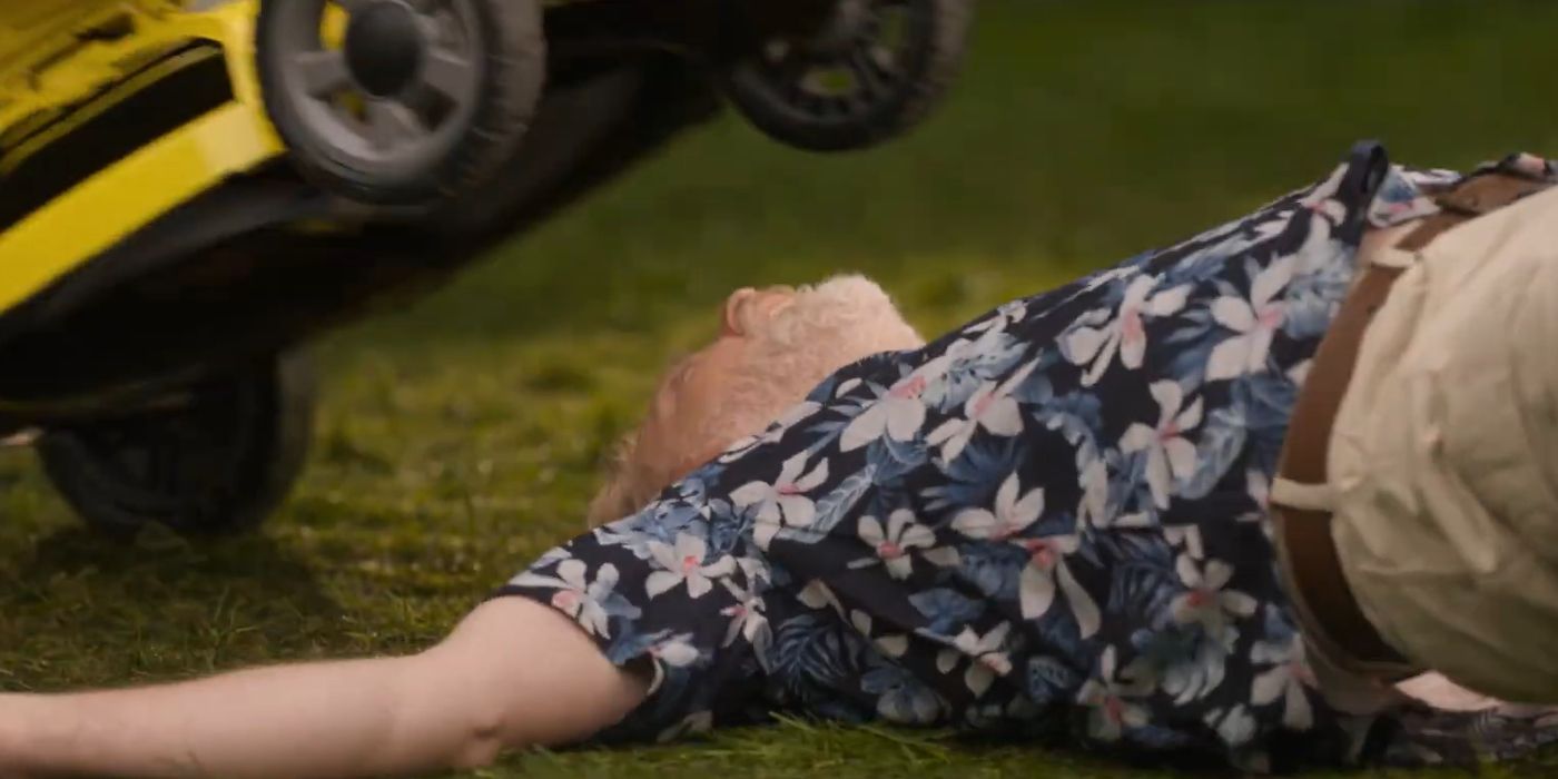 Alex Zahara as Howard Campbell lying on the grᴀss with a lawn mower above his head in Final Destination Bloodlines