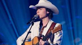 American Idol’s John Foster sings while playing the guitar