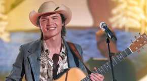 American Idol Season 23 Contestant John Foster Smiling On Stage