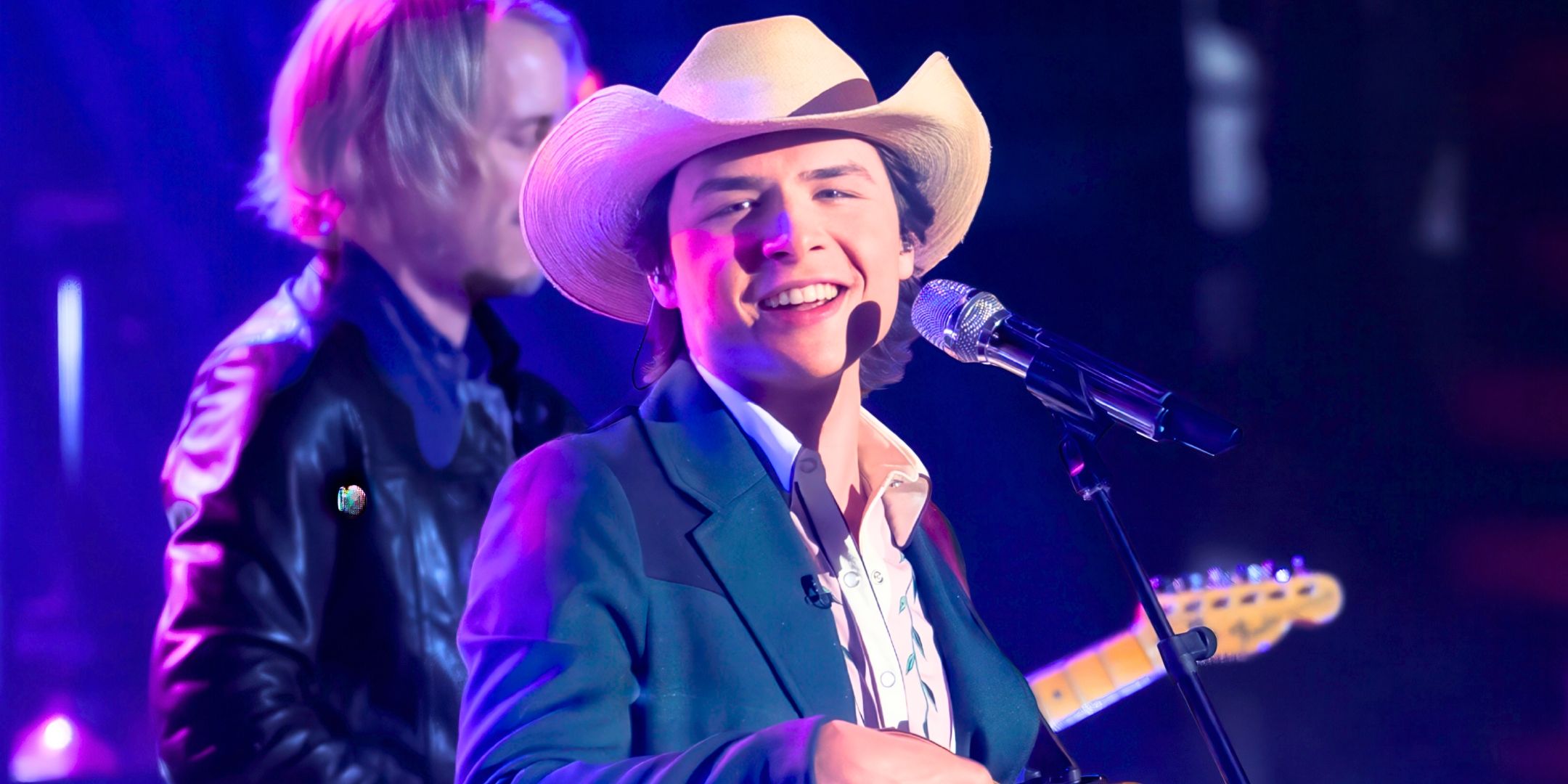 American Idol Season 23's John Foster smiles while performing on stage