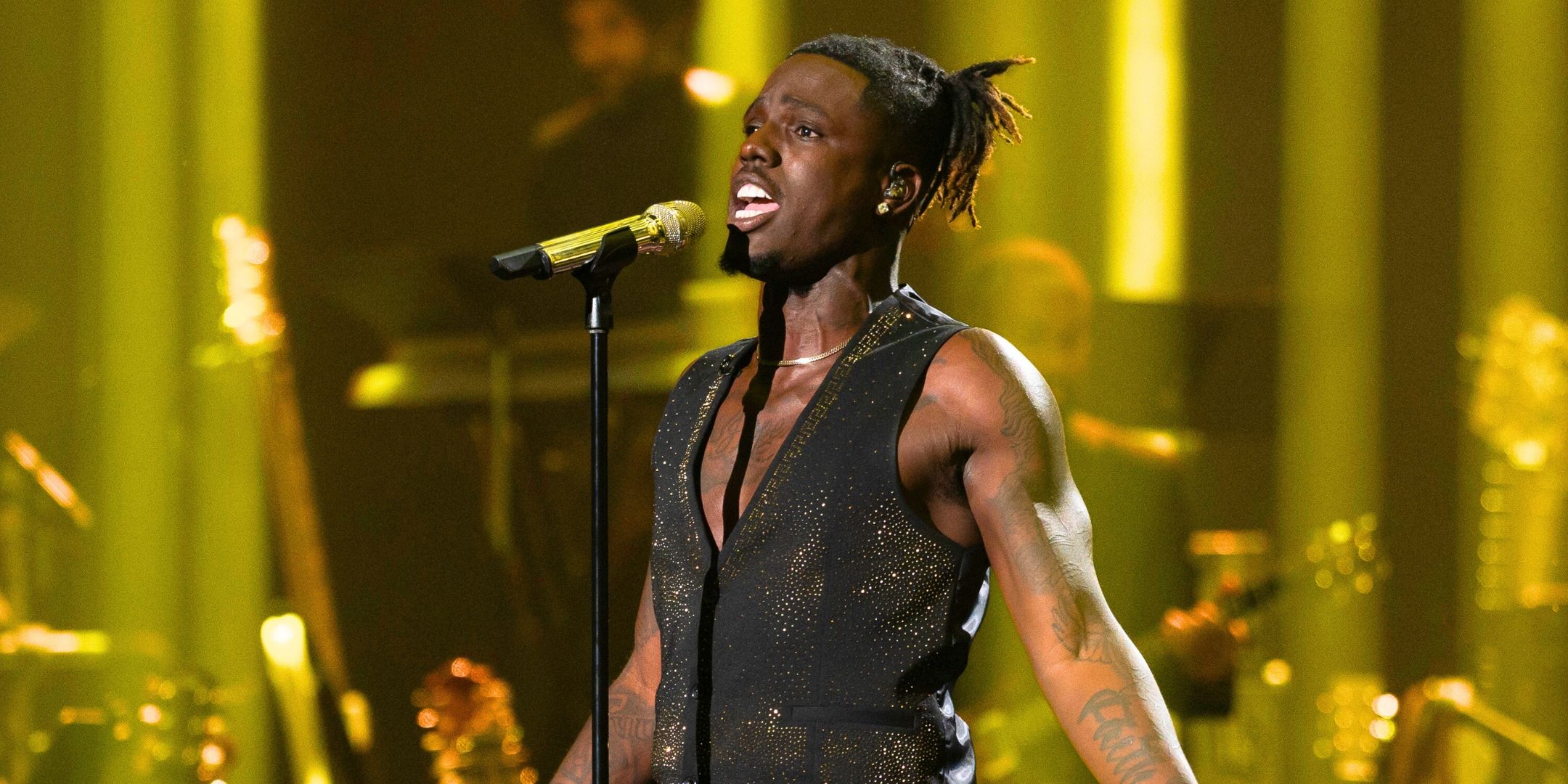 American Idol Winner Jamal Roberts sings on stage while holding out his arms