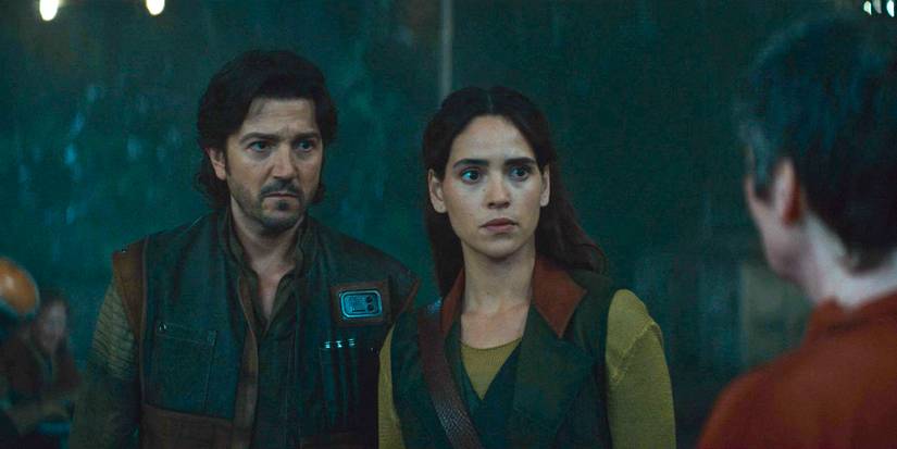 Cassian Andor (Diego Luna) and Bix Caleen (Adria Arjona) speaking to a Force healer in Andor Season 2 Episode 7