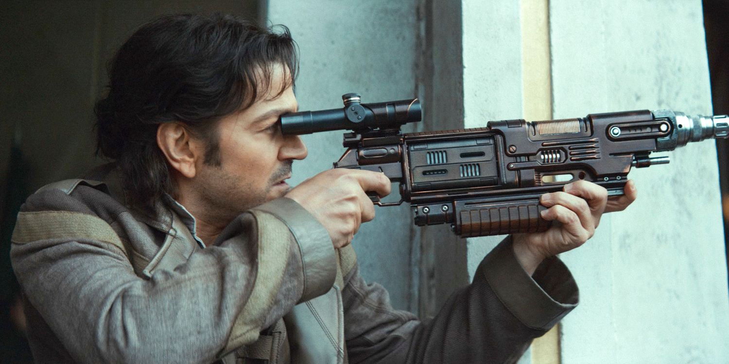 Cassian Andor holding up a blaster during the Ghorman Massacre in Andor season 2 episode 8
