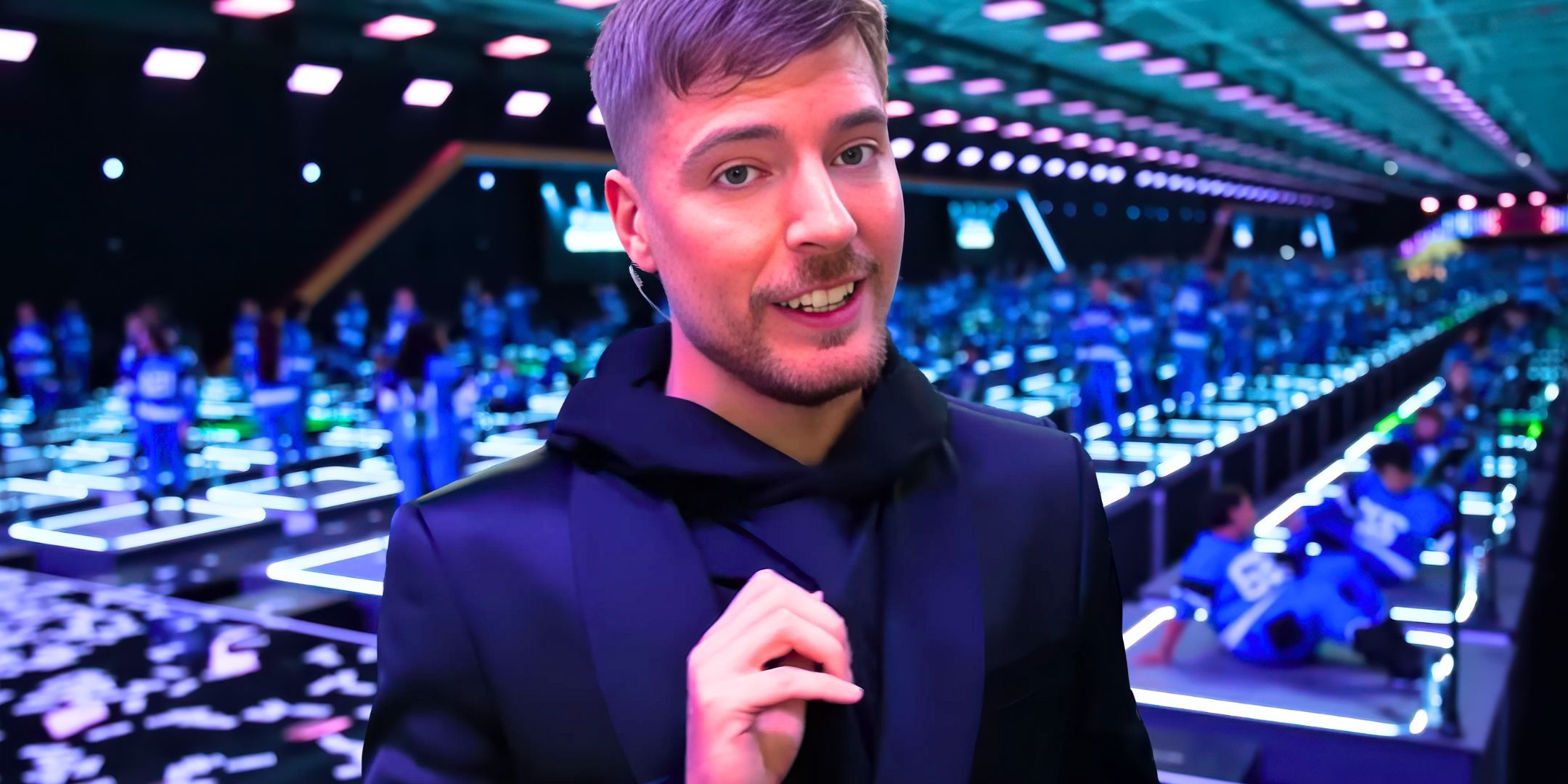 Beast Games' MrBeast talks to the camera with the game behind him